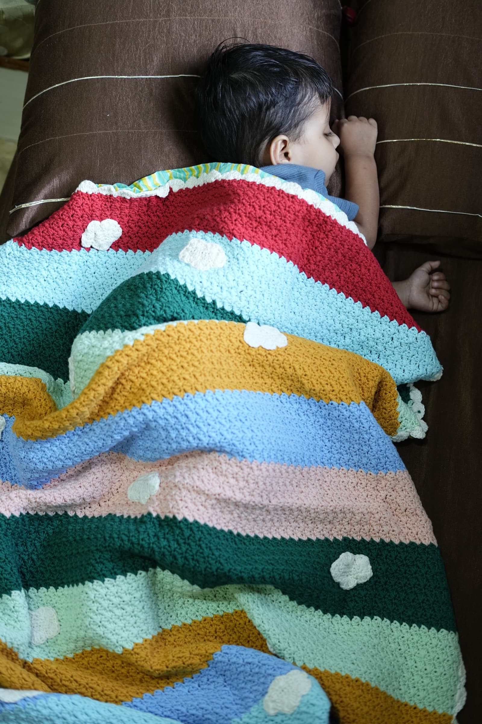 Rainbow Nest striped crochet blanket with cream cloud appliqués
