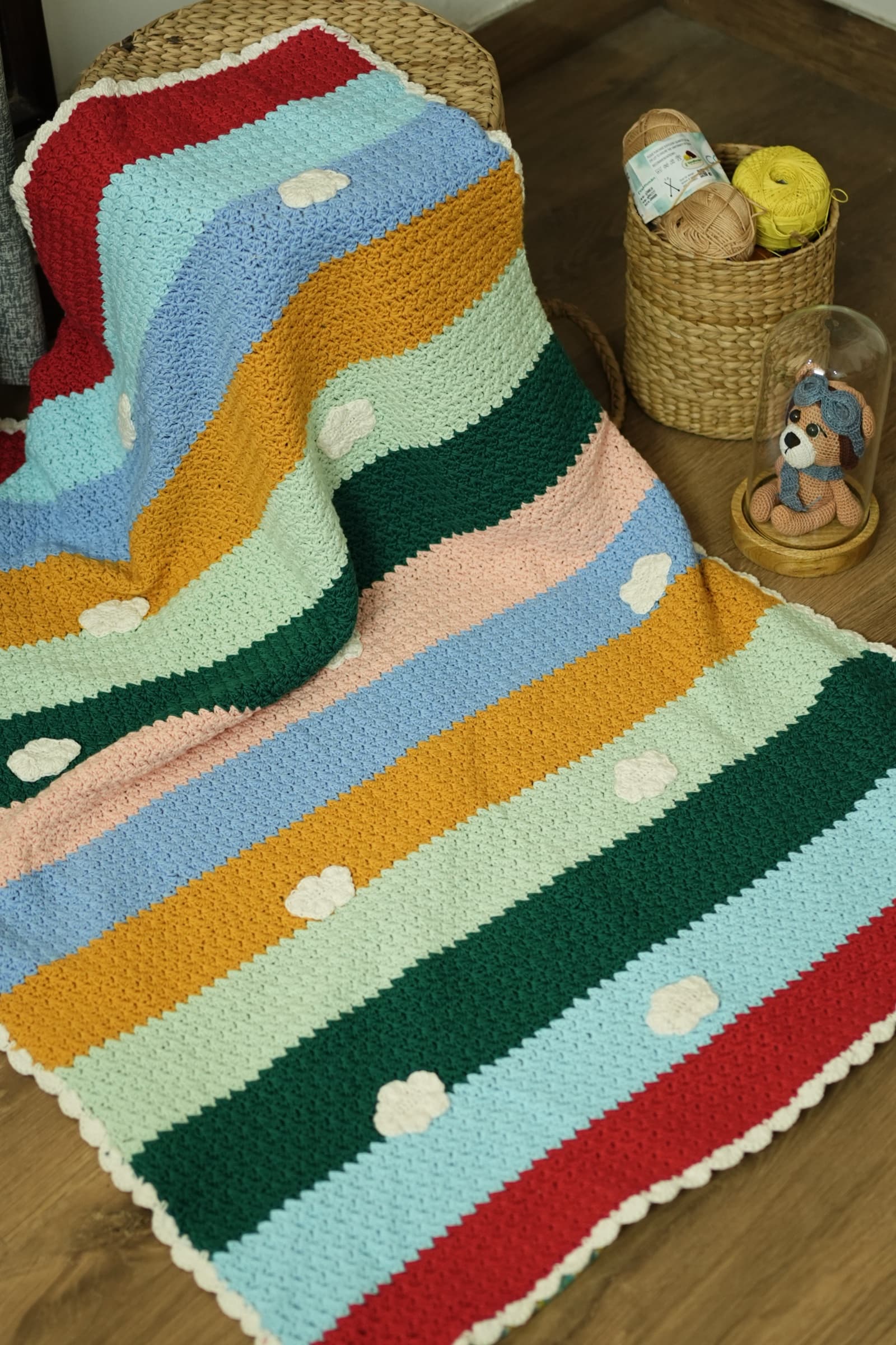 Rainbow Nest striped crochet blanket with cream cloud appliqués